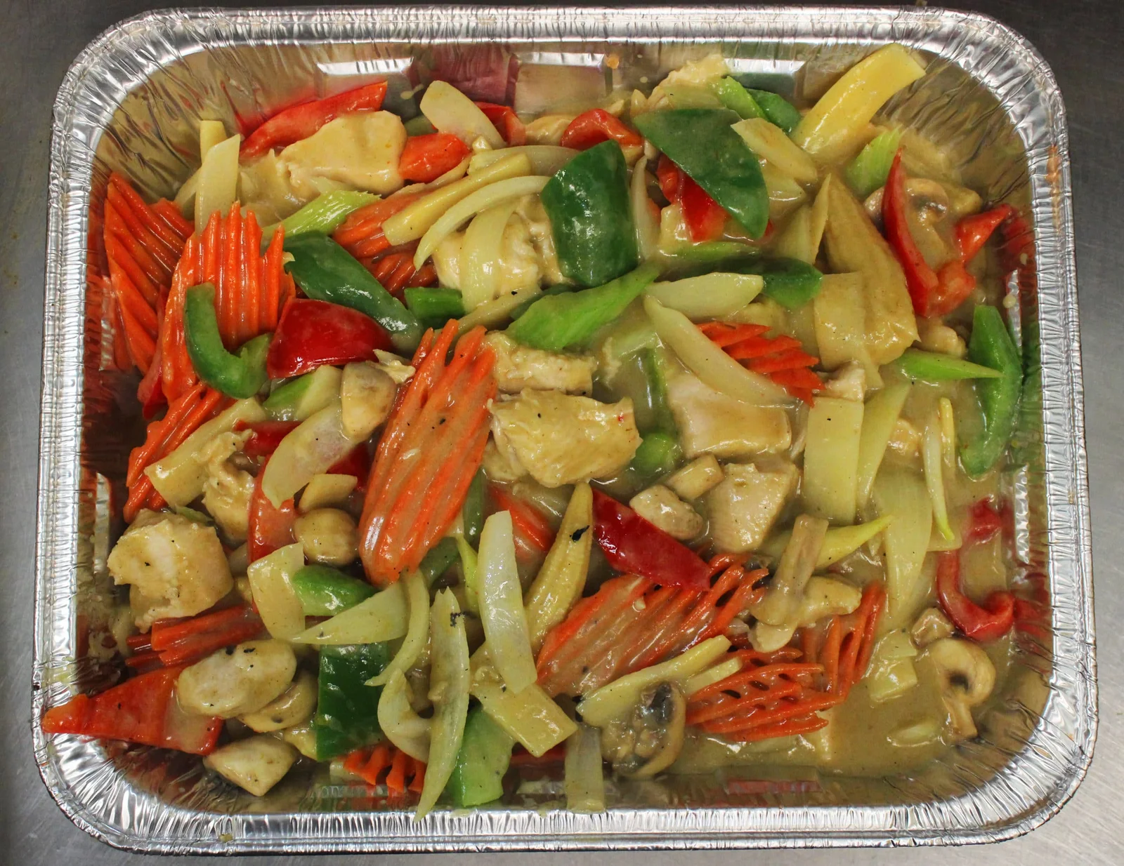 Catering tray of stir-fried vegetables and chicken