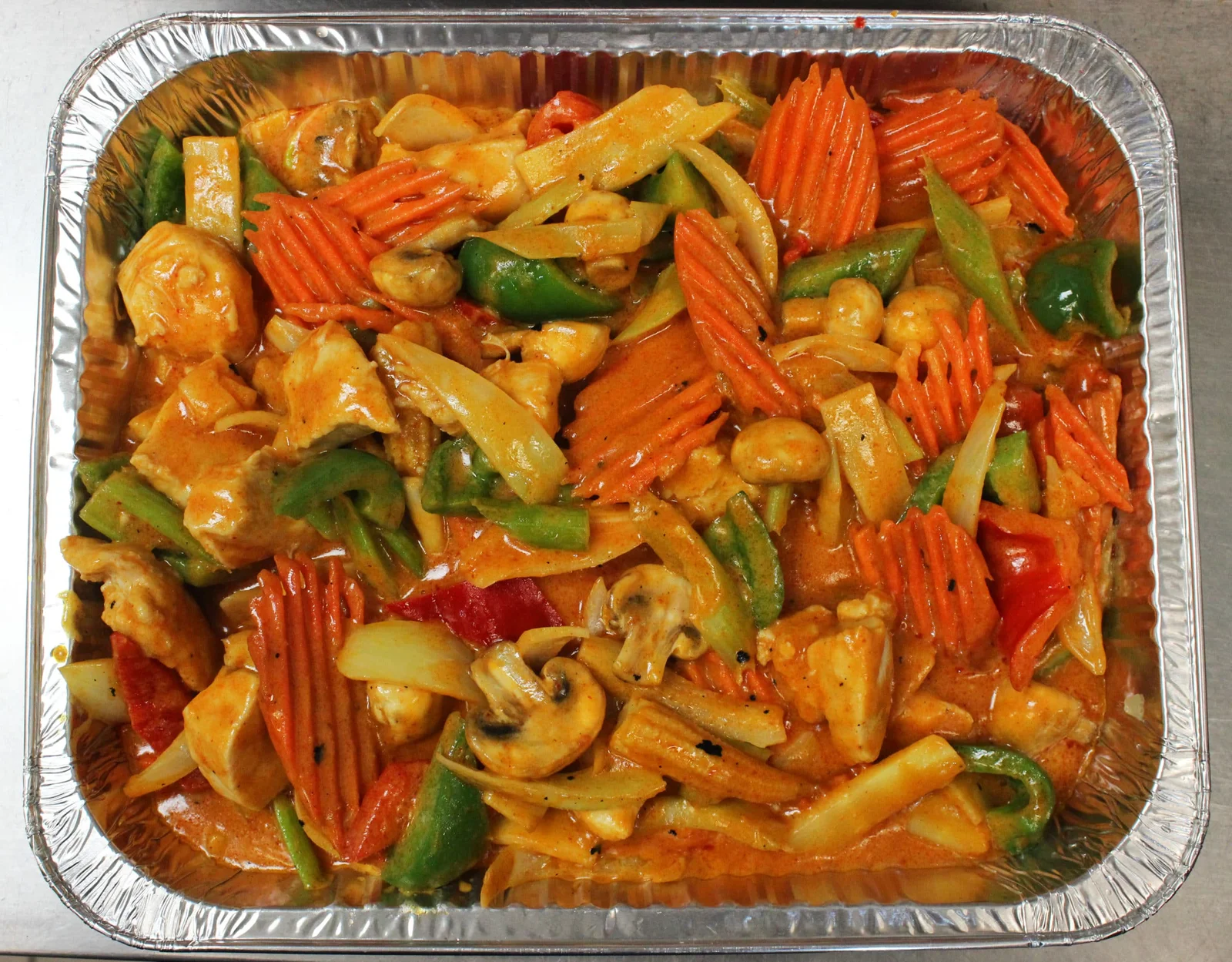 Aluminium catering tray of stir-fried chicken with vegetables