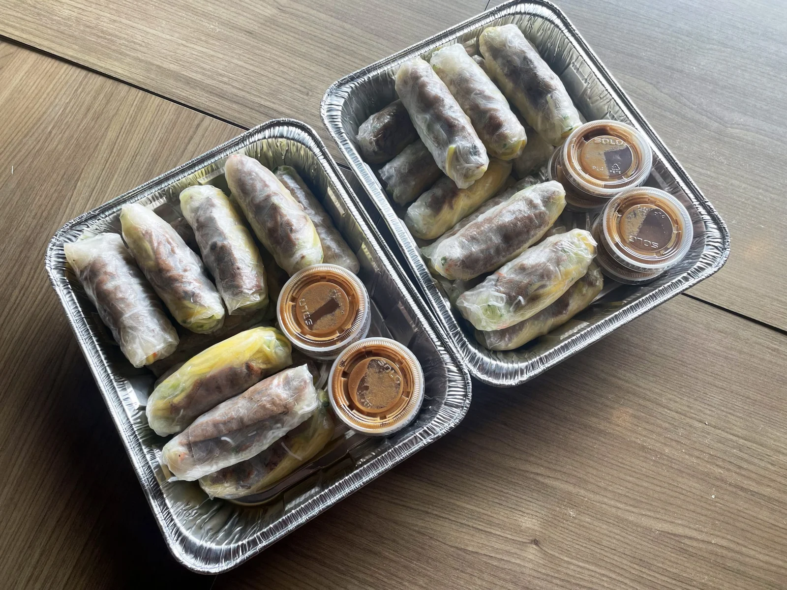 Fresh rolls packed in trays with sauce cups